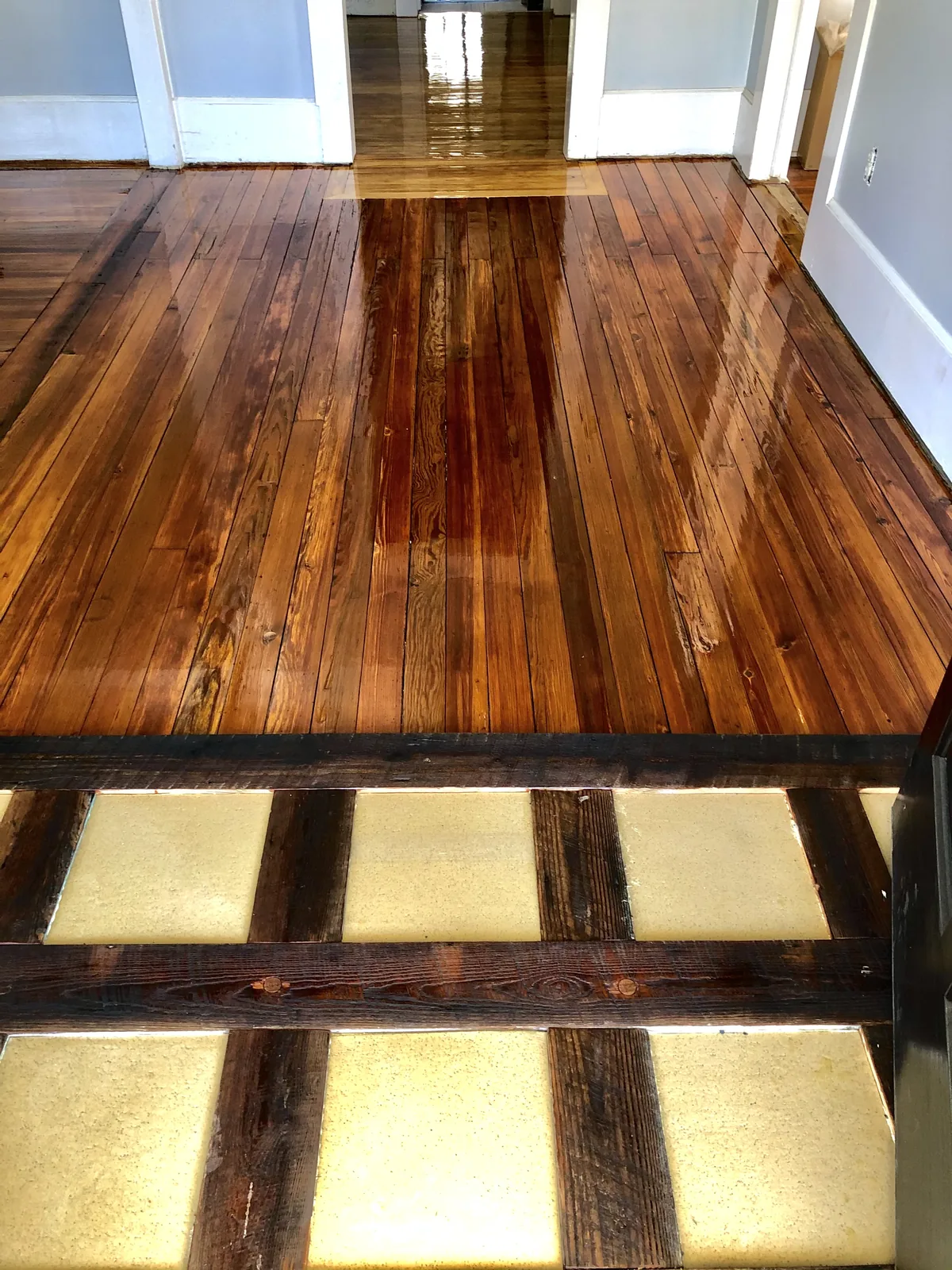 Refinished antique heart pine floor with sunlight falling across the boards