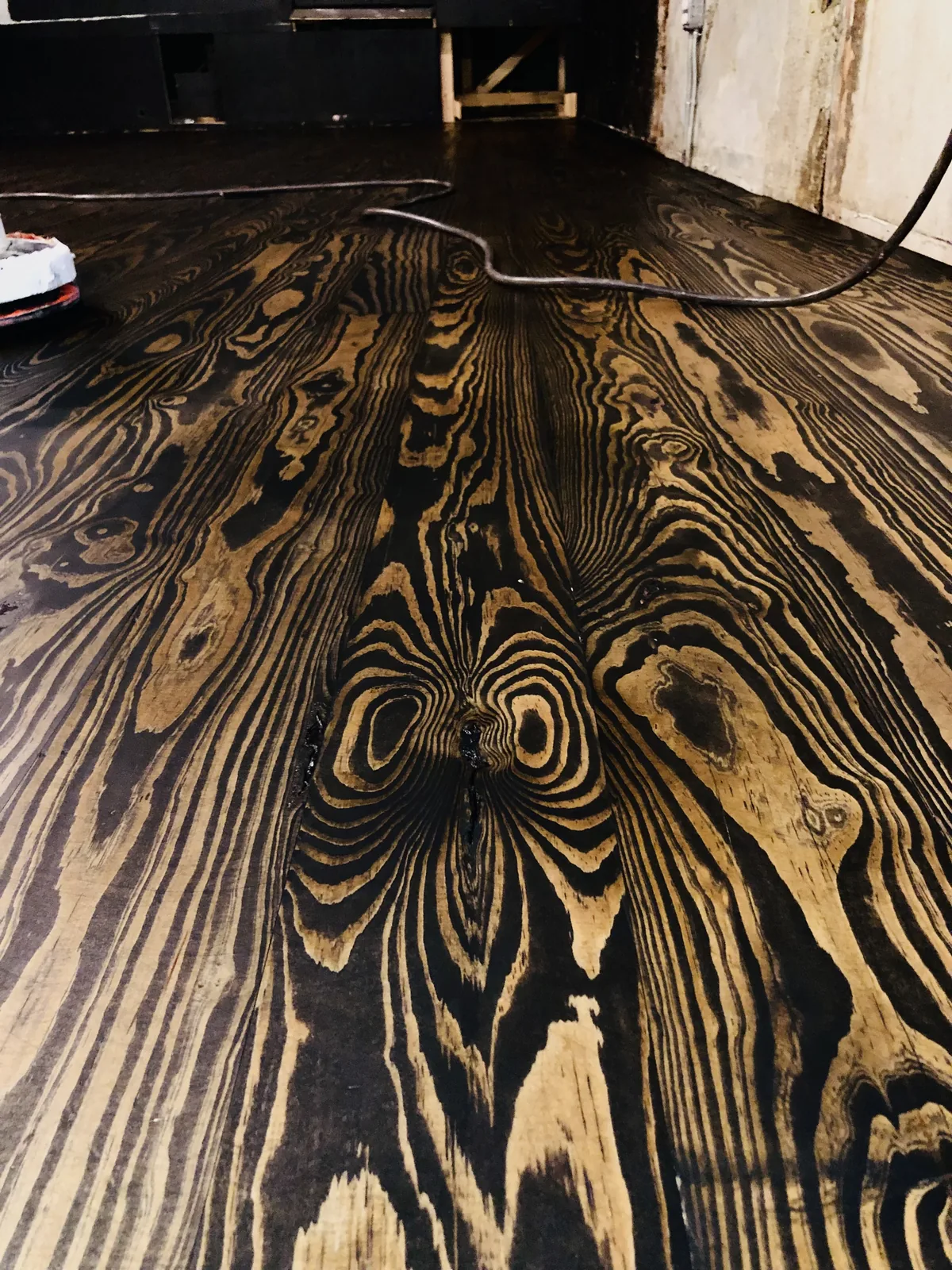 Ebonised heart pine floor with dramatic gold figured grain