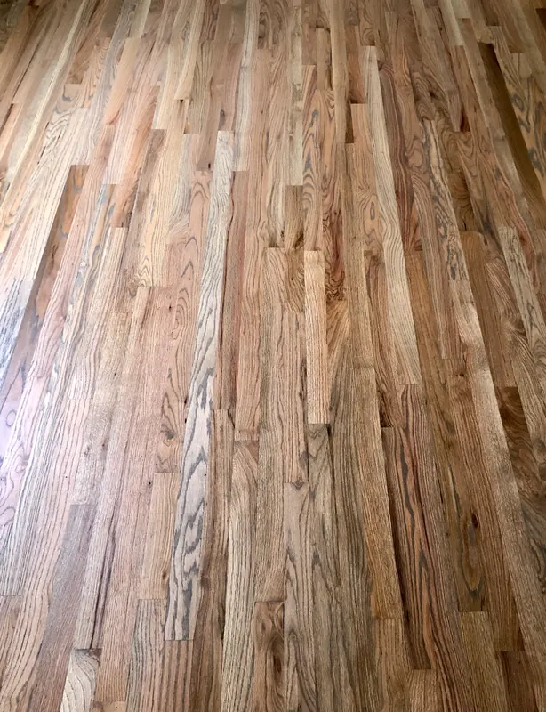 Pale red oak floorboards photographed from above