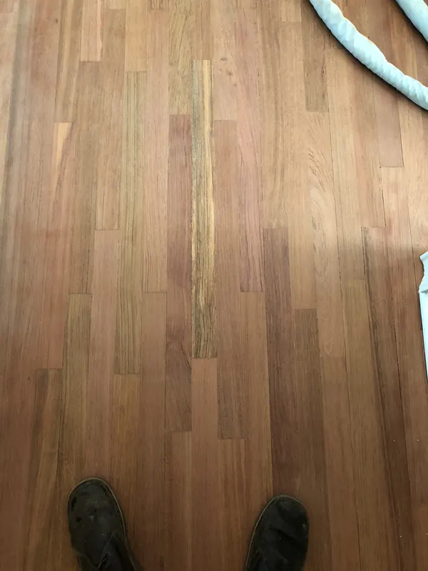 Boots on newly laid pale hardwood flooring