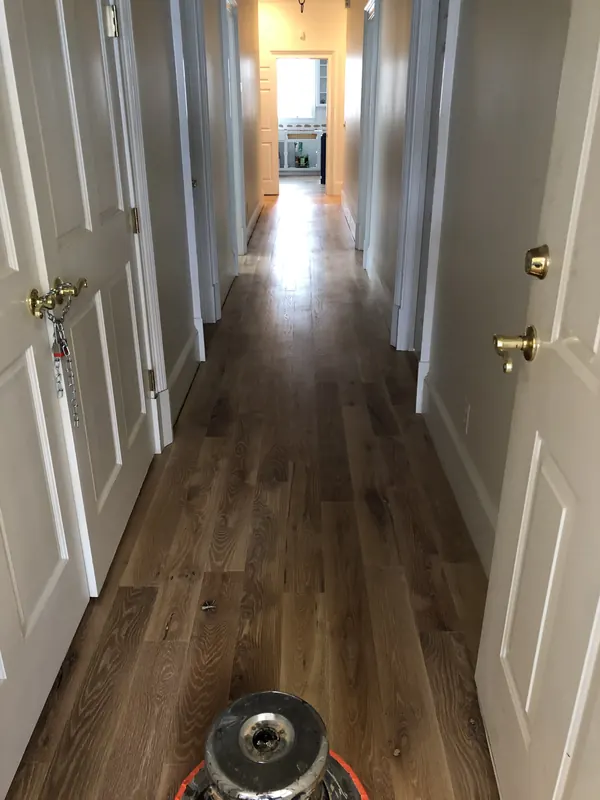 Floor buffer at the end of a long hallway with doors either side