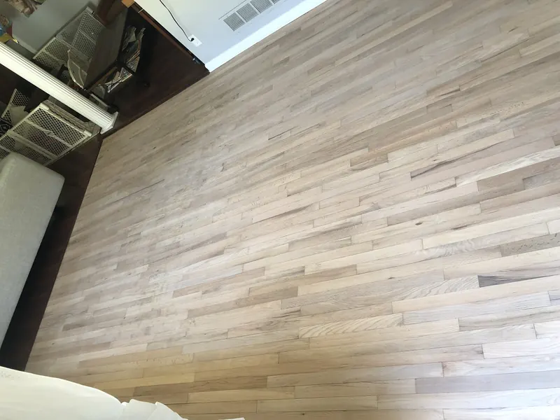 Light oak flooring seen at a low angle across a finished room