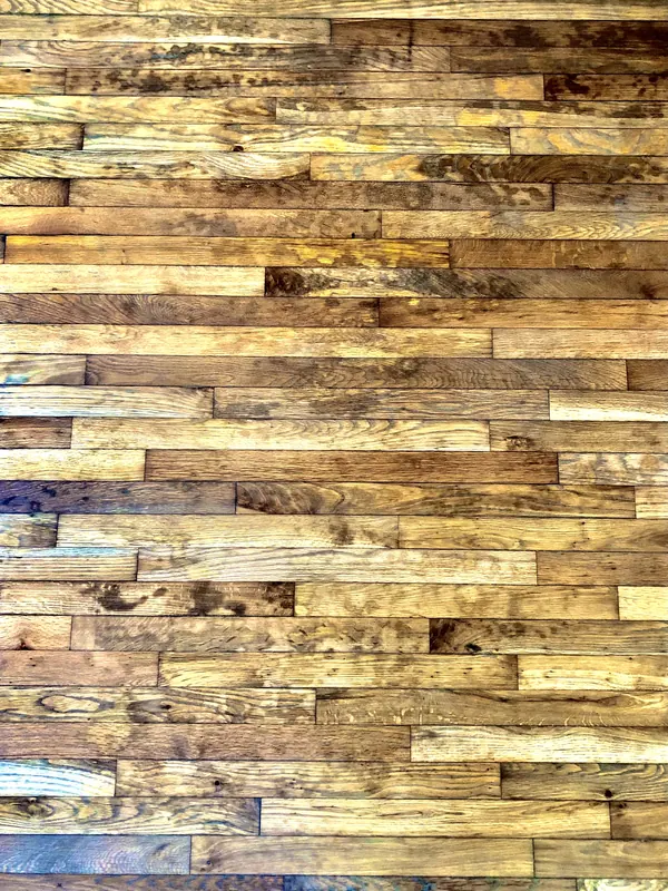 Patchwork of reclaimed planks in golds, browns and greys