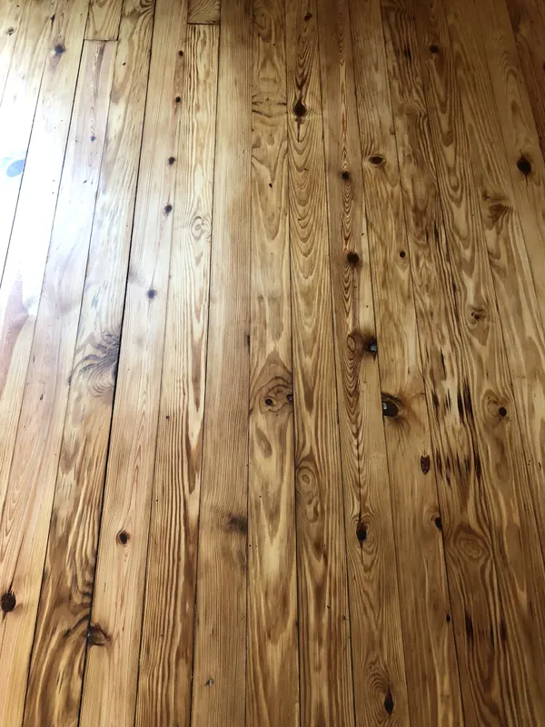 Warm pine boards with dark knots and even sheen