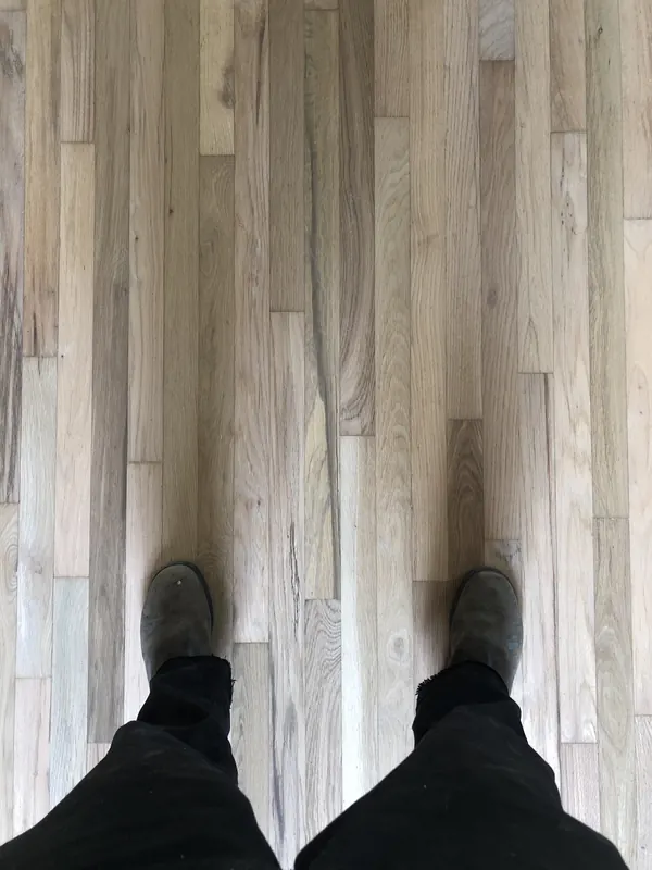 Boots on pale grey plank flooring