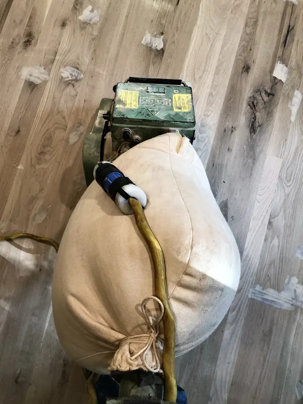 Drum sander on oak flooring mid-cut