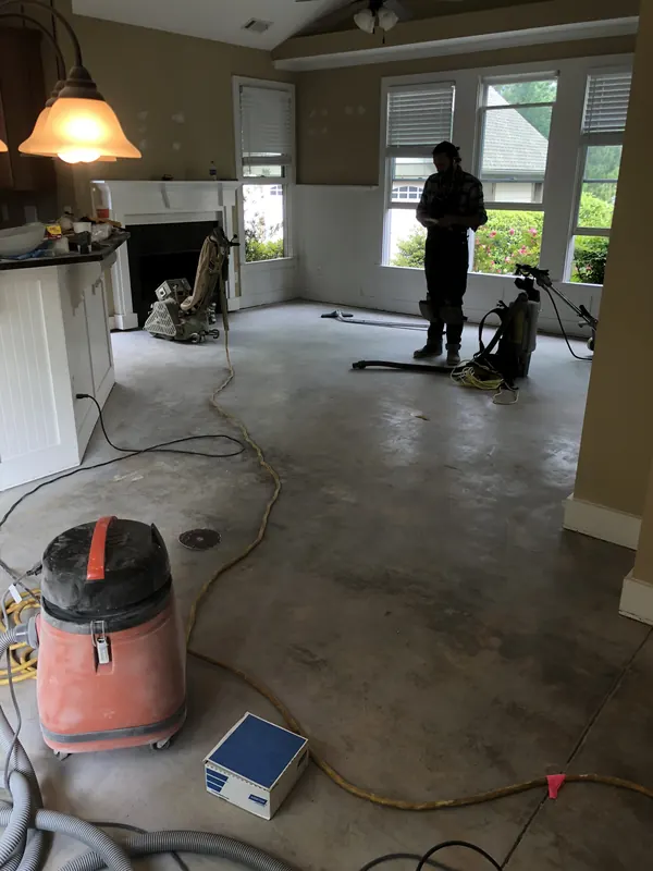 Room taken back to concrete with crew and equipment