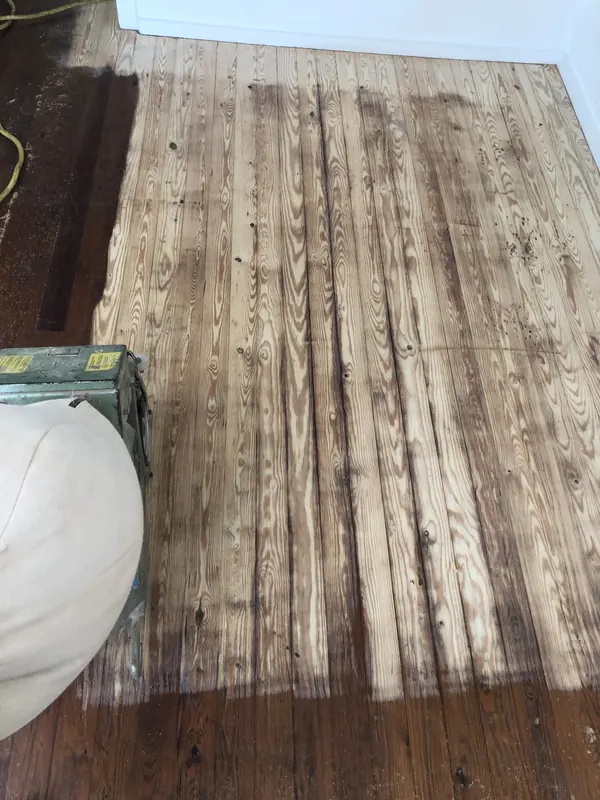 Worn grey floorboards with old finish failing