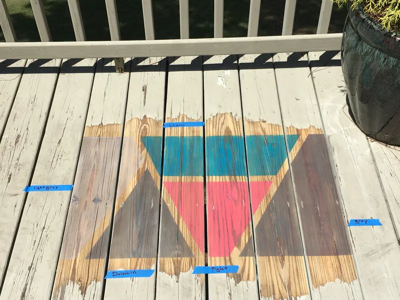 Deck boards with a painted chevron design and masking tape