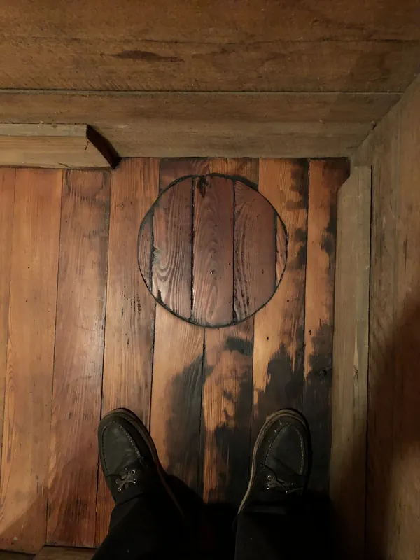 Circular inlay ring set into dark weathered planks
