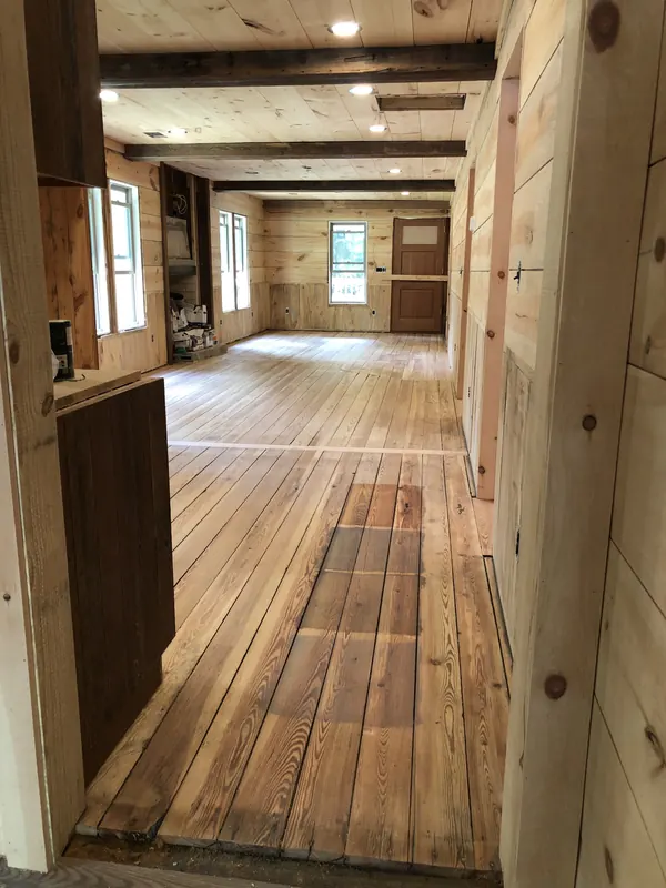 Long heart pine floor framed by timber posts and beams