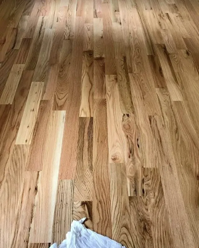 Light oak boards part-laid across a bright room