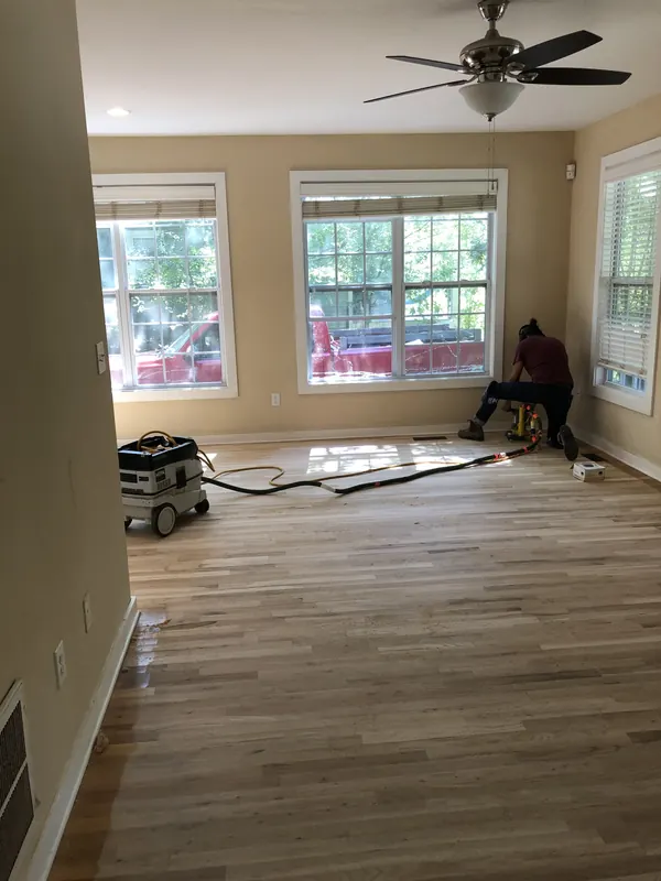 Room with bay windows and flooring part-laid