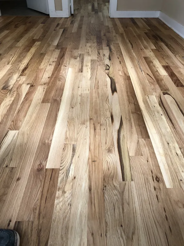 Pale oak boards laid beside slightly darker existing floor