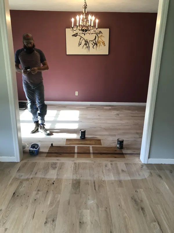 Dining room mid-installation with a chandelier overhead