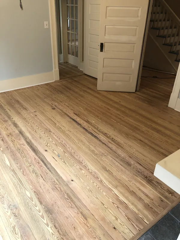 Light pine floor beside a white staircase