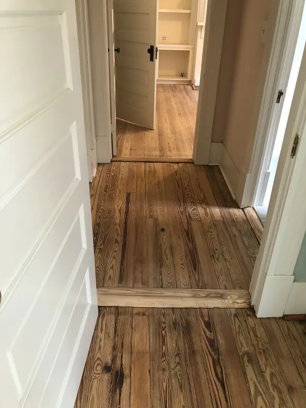 View through a doorway onto warm heart pine boards