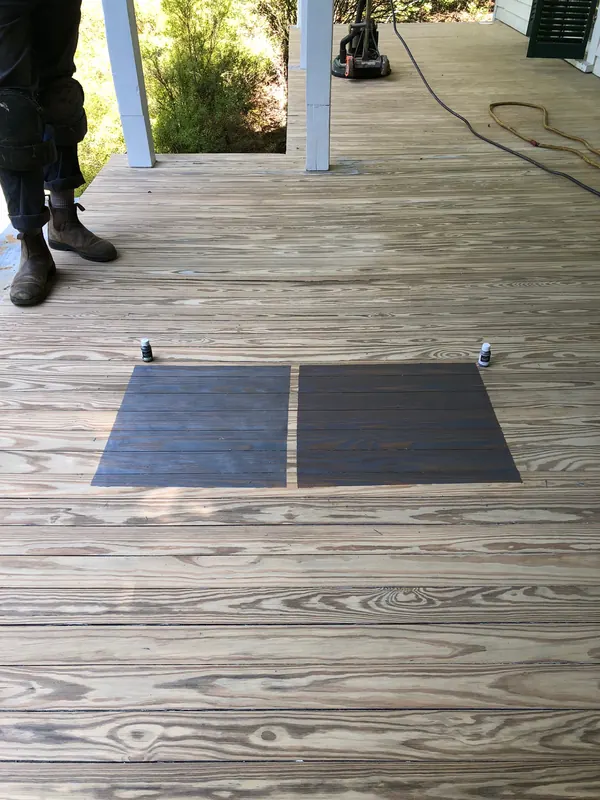 New porch decking with a dark panel resting on it