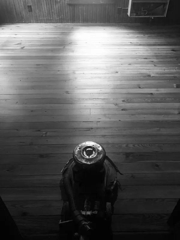 Black and white shot of a sander lit by a single work light