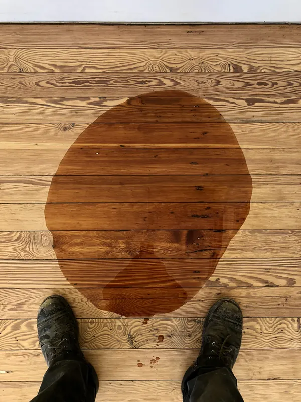 Circular wood patch let into a pine floor