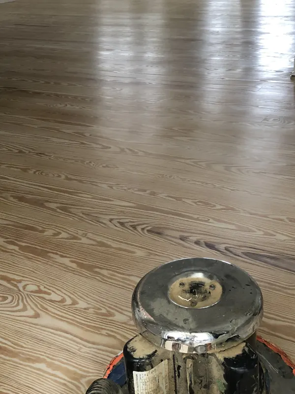 Floor buffer on warm figured heart pine