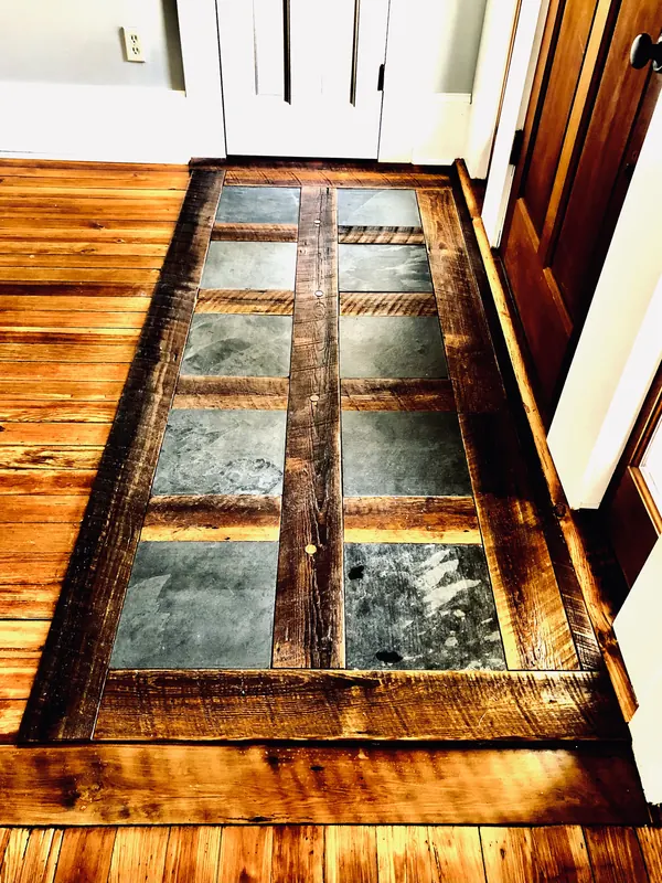 Row of dark glass panels inlaid into a warm timber floor