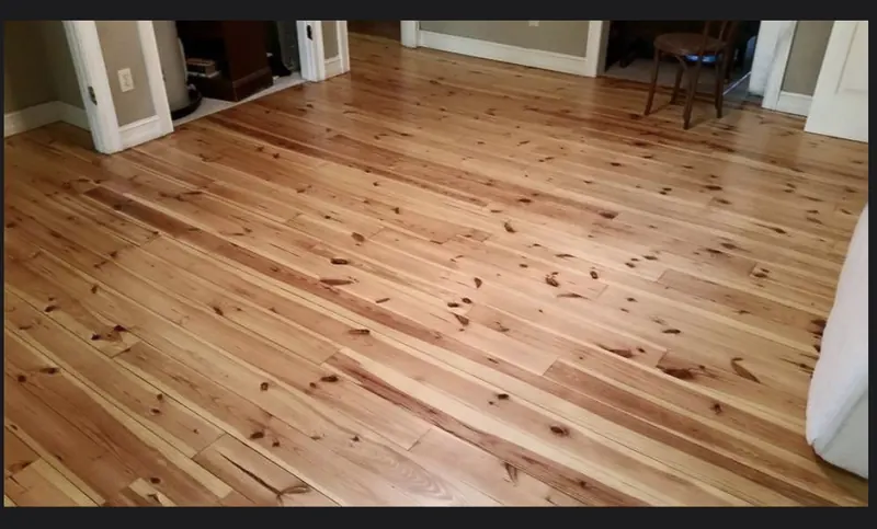 Wide knotty pine floor in a bright finished room