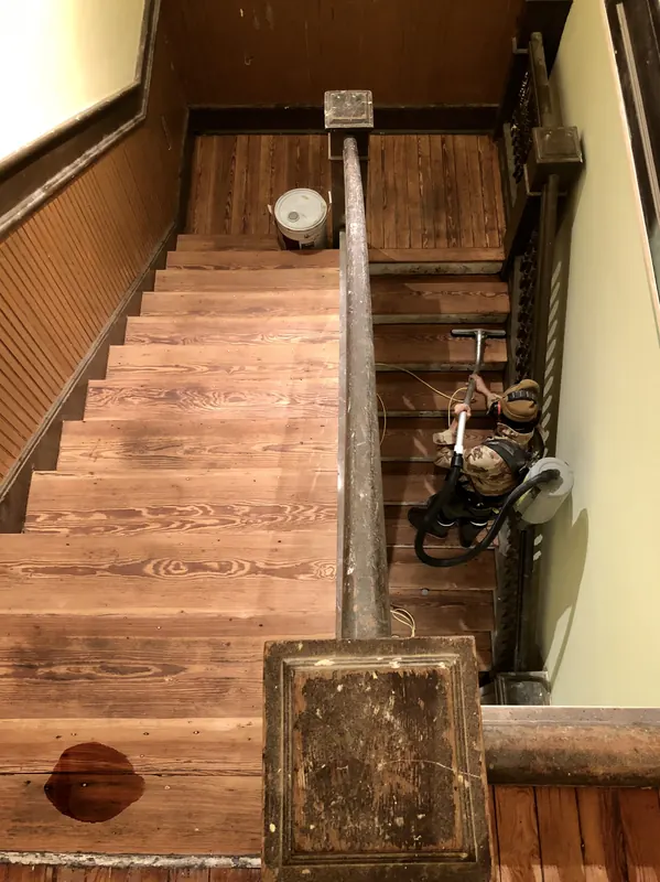Historic staircase with worn treads and panelled wall