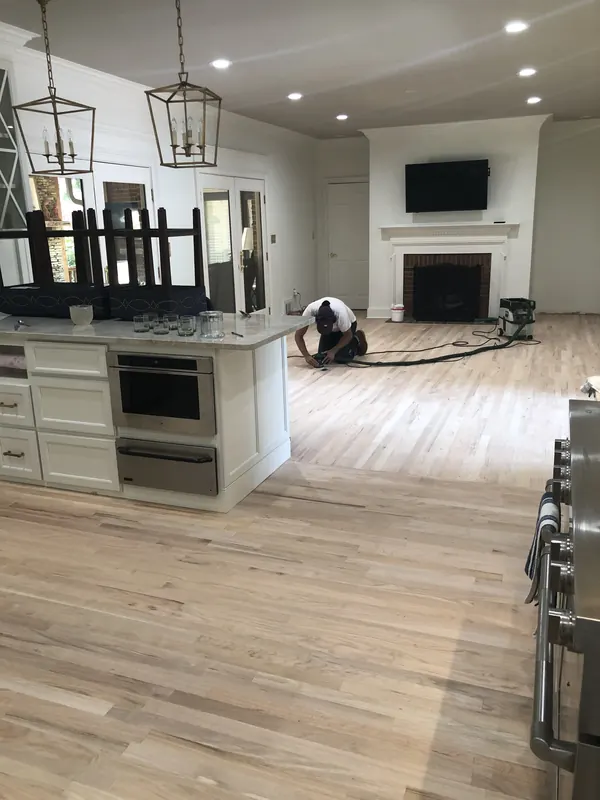 Modern kitchen with island above wide light oak boards