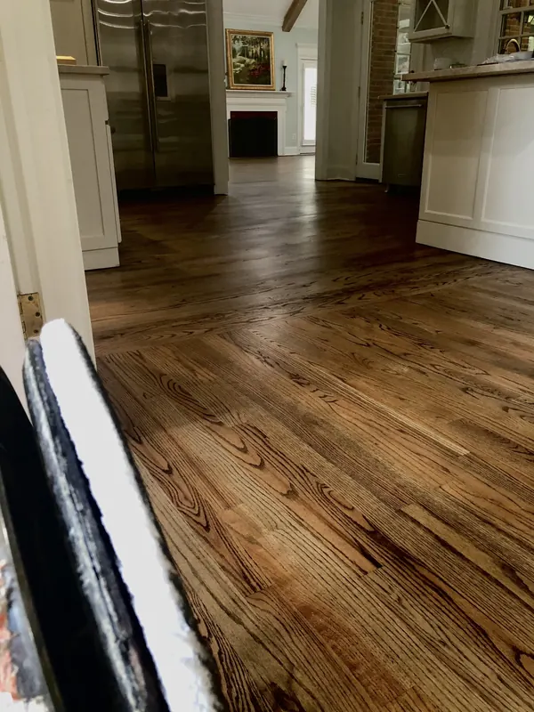 Warm reclaimed pine floor running through an open kitchen