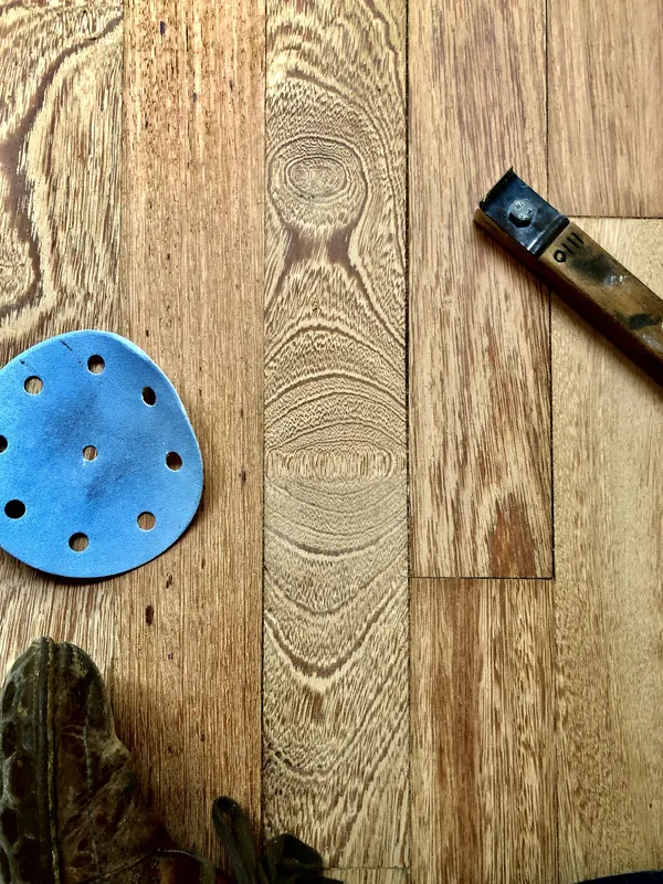 Tape and tool resting on a heart pine board