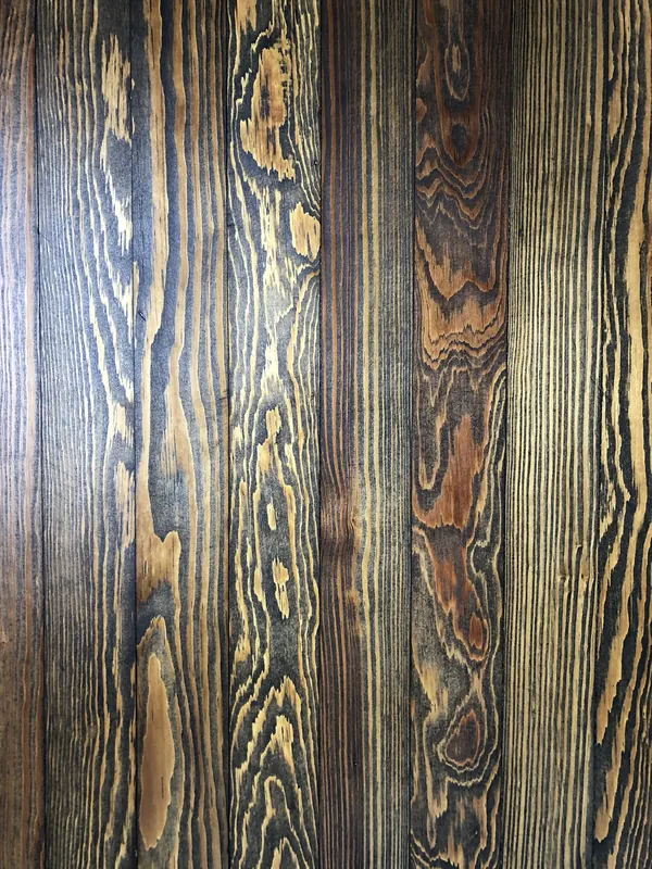 Near-black boards with strong golden grain figure