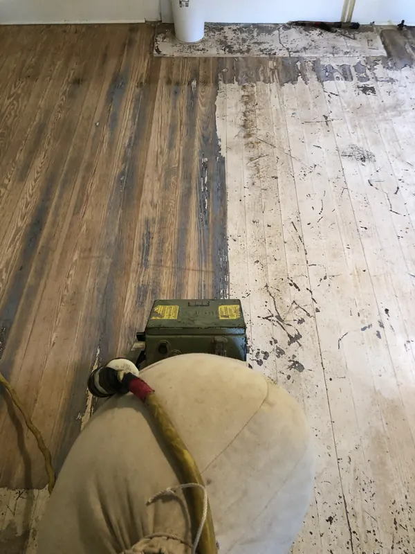 Sander on a heavily worn pale floor