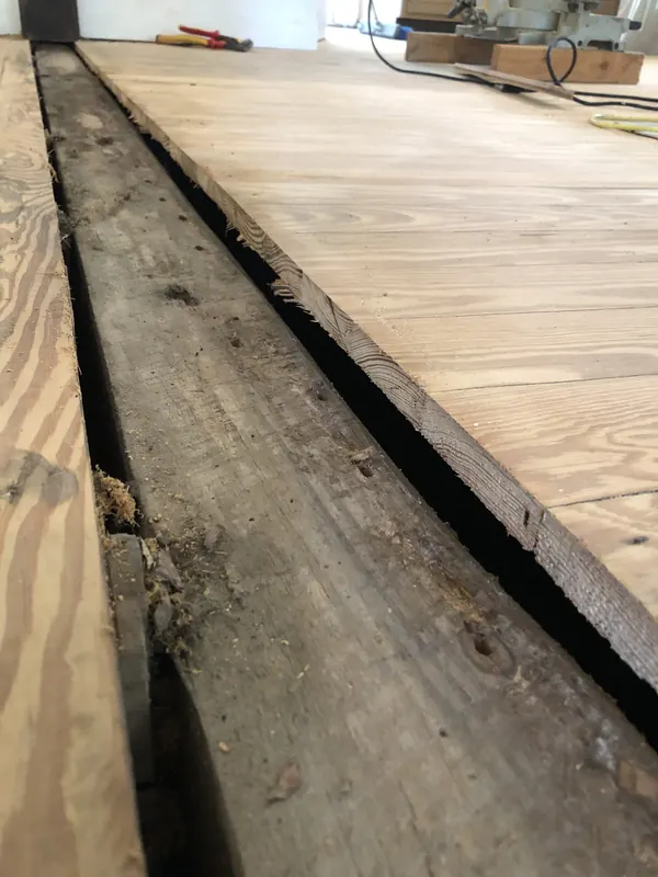 Very wide rough boards laid out on the floor