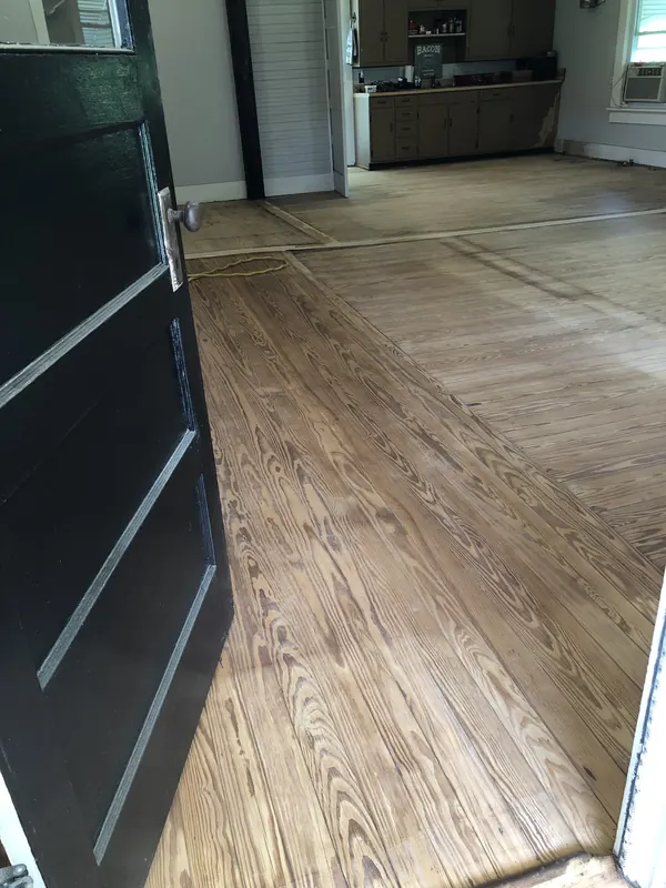 Light oak floor running past dark cabinetry