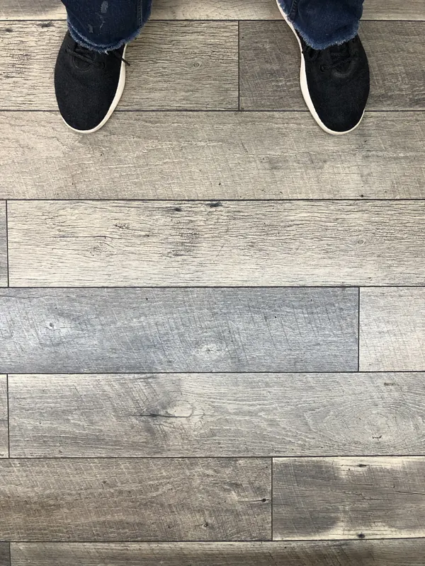Boots on wide grey-toned plank flooring
