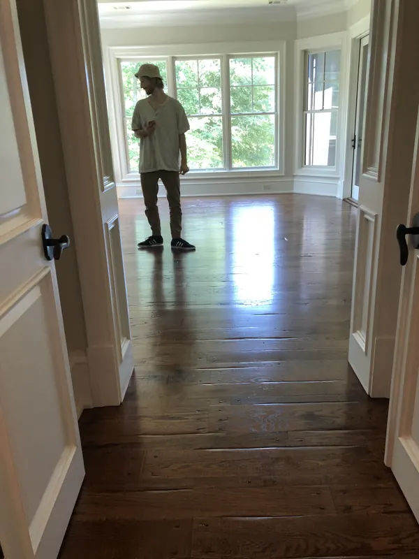 Craftsman standing at the end of a long glossy floor