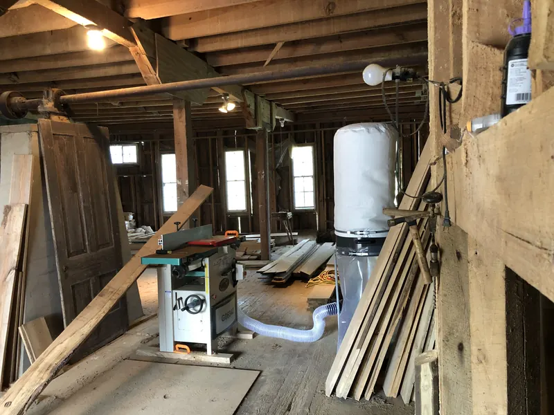 Timber workshop with stacked boards and machinery