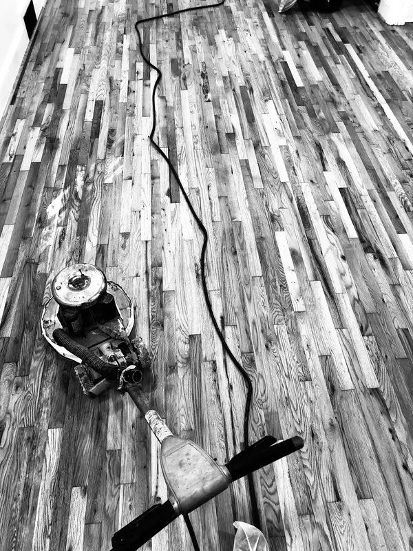 Black and white sander on a pale floor