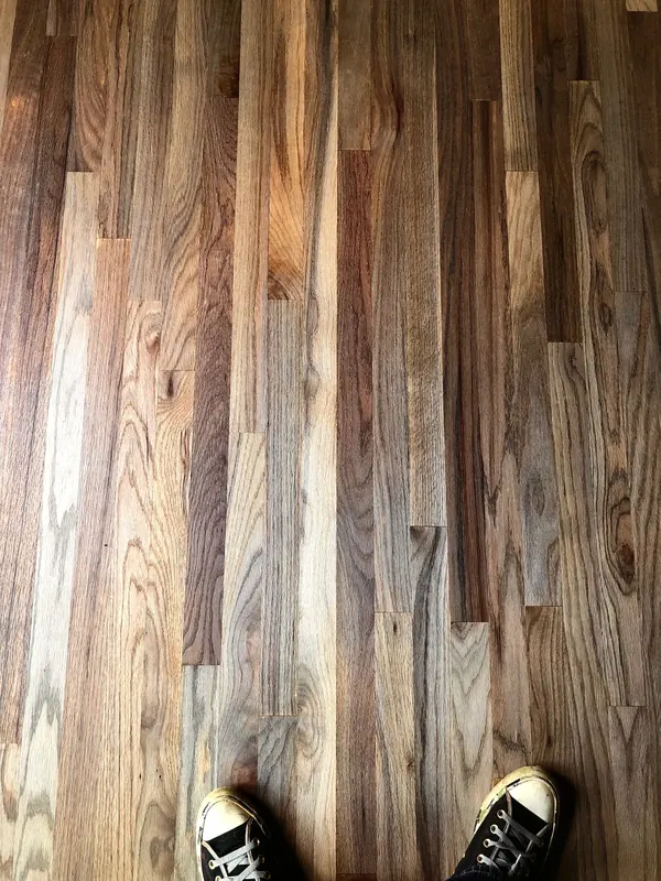 Pale oak boards part-laid with boots at the edge