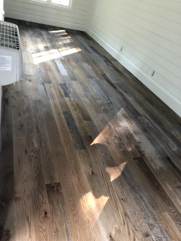 Pale grey floor reflecting window light