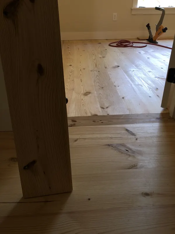 Pale floor beside a heavy timber post