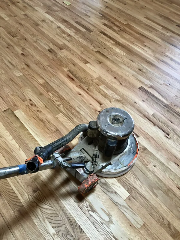 Floor buffer on pale oak boards
