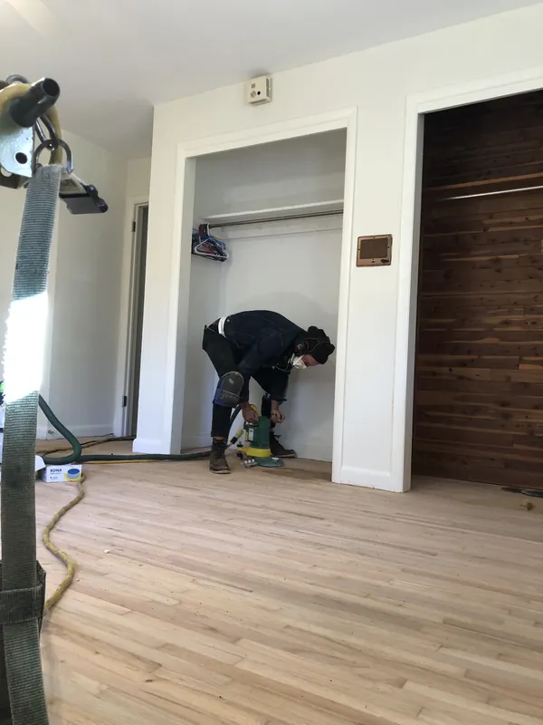 Craftsman fitting flooring inside a closet opening